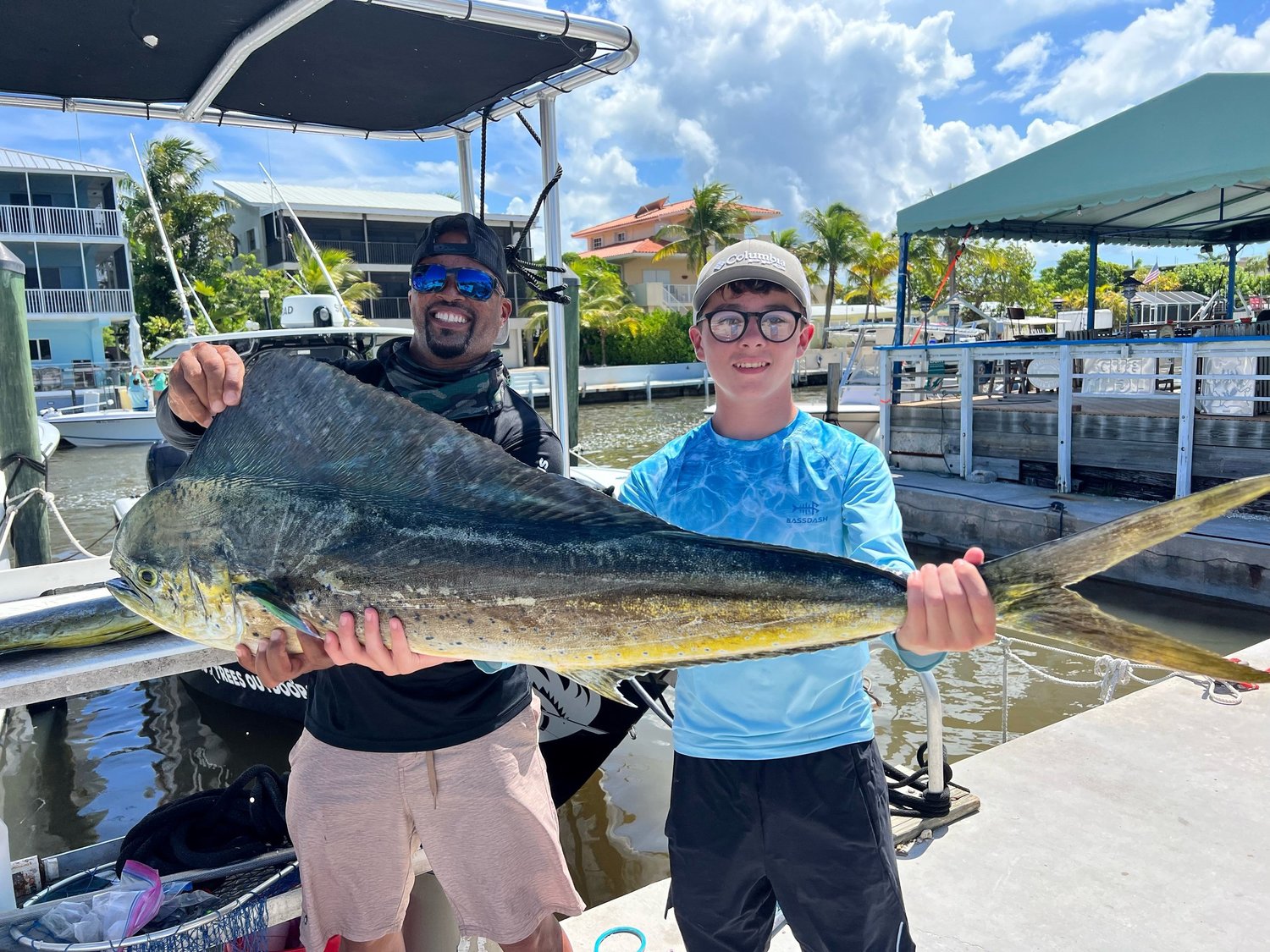 Guest holding a large mahi mahi at the dock